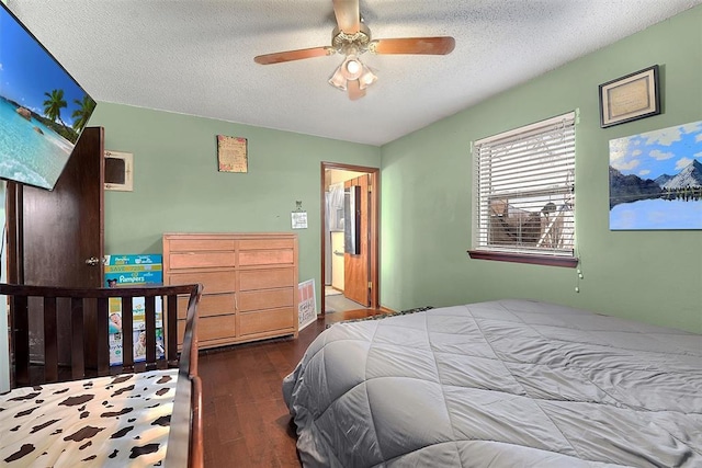 bedroom featuring a ceiling fan, wood finished floors, and a textured ceiling