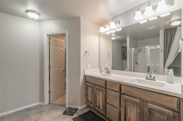 full bathroom with double vanity, visible vents, a shower stall, and a sink