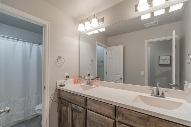 full bathroom featuring double vanity, toilet, visible vents, and a sink