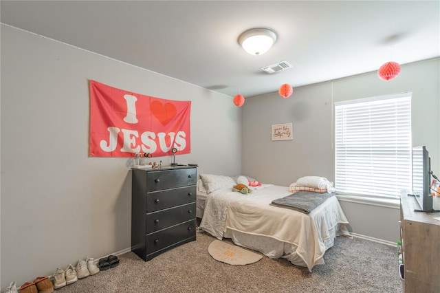 carpeted bedroom with visible vents and baseboards