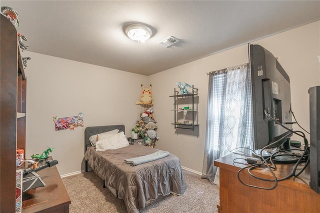 bedroom featuring visible vents, light carpet, and baseboards