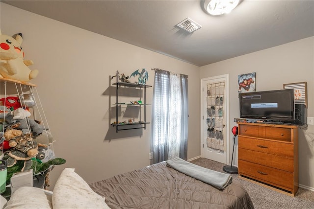 carpeted bedroom featuring visible vents