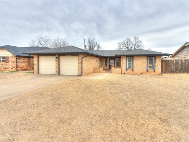 ranch-style house with brick siding, a shingled roof, fence, a garage, and driveway