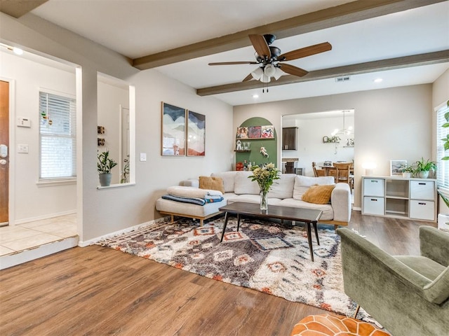 living room with beam ceiling, a ceiling fan, baseboards, and wood finished floors