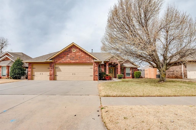 ranch-style house featuring driveway, brick siding, an attached garage, and a front yard