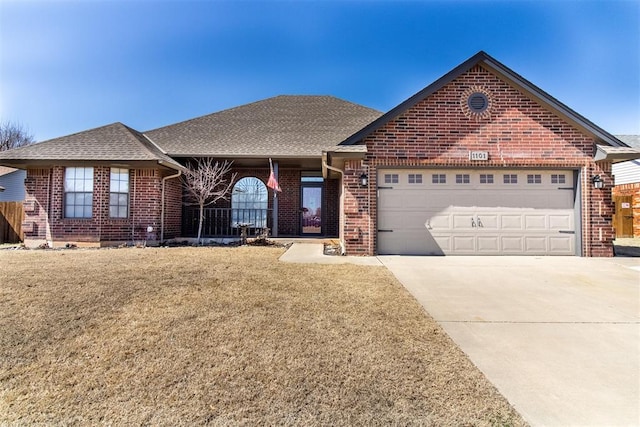 single story home with a garage, brick siding, and driveway