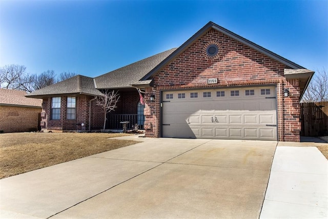 single story home featuring fence, driveway, roof with shingles, a garage, and brick siding