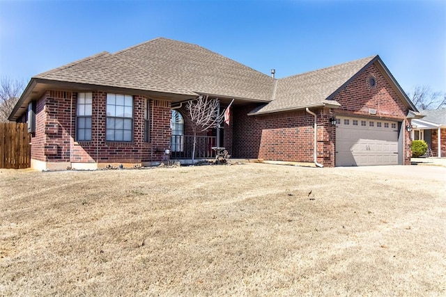 view of front facade featuring a garage, brick siding, driveway, and a shingled roof