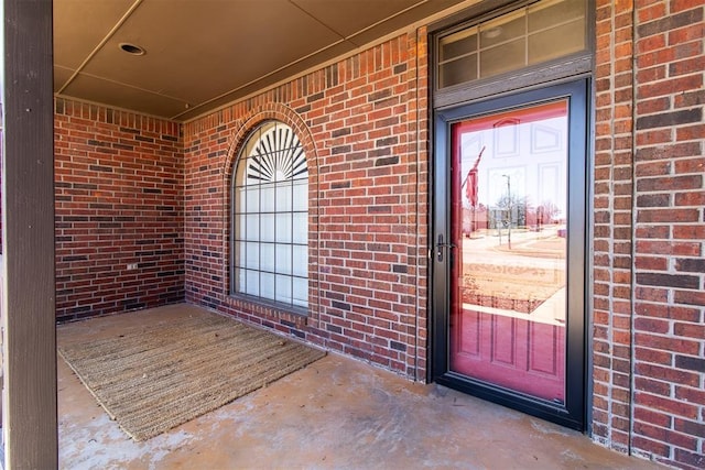 property entrance with brick siding