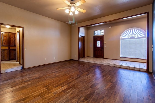 entryway featuring baseboards, ceiling fan, and wood finished floors