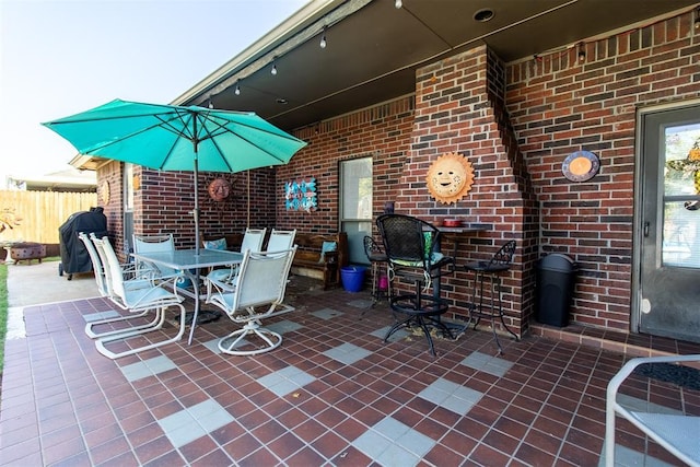 view of patio / terrace with outdoor dining space and fence