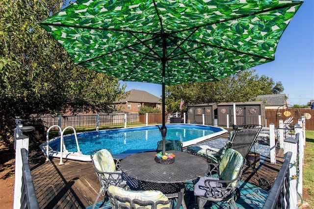 view of pool with outdoor dining space, a fenced backyard, and a fenced in pool