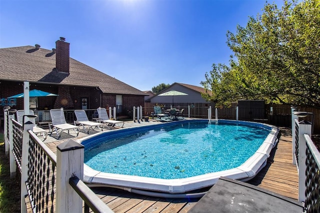 view of pool with a fenced in pool, a patio, and fence