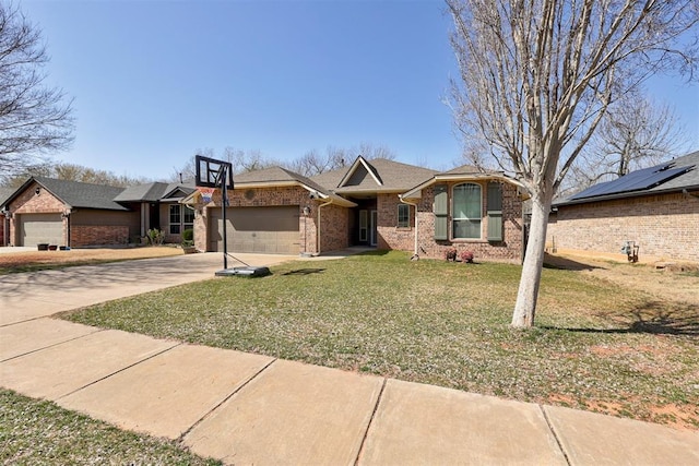 single story home featuring brick siding, a garage, driveway, and a front lawn