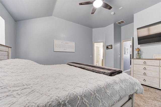 bedroom with vaulted ceiling, light colored carpet, visible vents, and ceiling fan