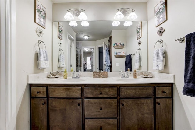 full bathroom with double vanity, visible vents, and a sink