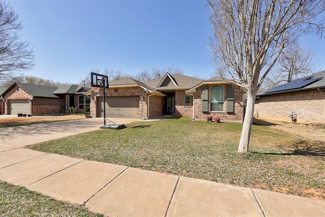 ranch-style home featuring a garage, concrete driveway, a front lawn, and brick siding