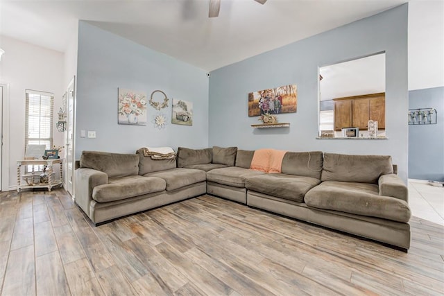 living room with a ceiling fan and light wood-style floors