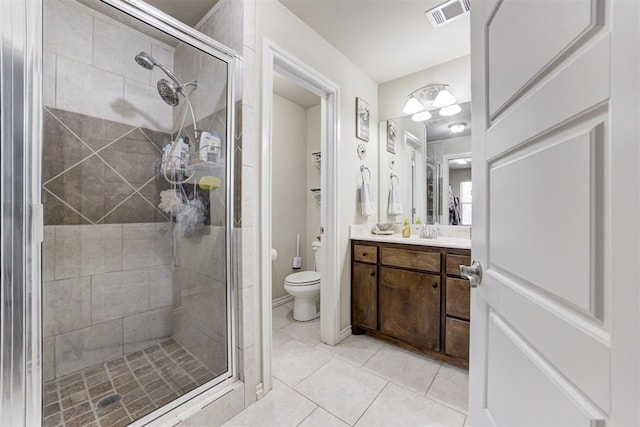 bathroom with visible vents, vanity, tile patterned flooring, toilet, and a shower stall
