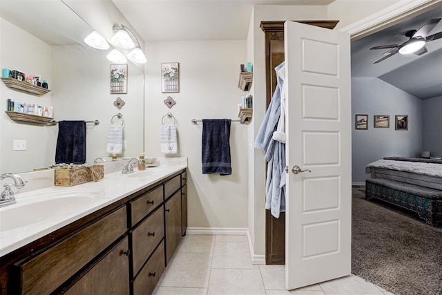 bathroom with double vanity, a sink, a ceiling fan, and tile patterned flooring