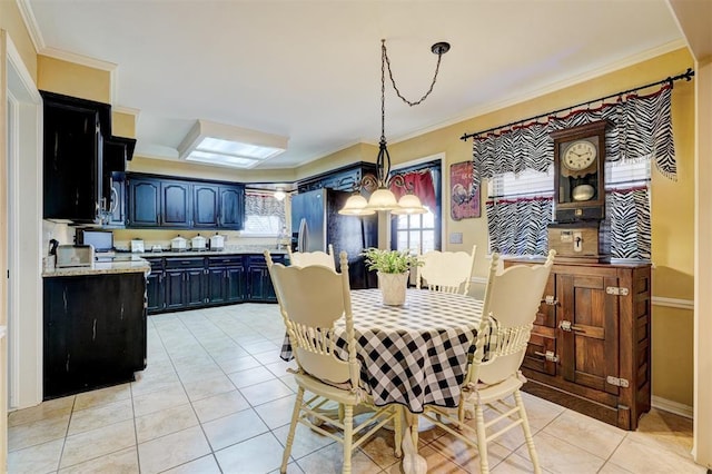 dining room featuring light tile patterned floors and ornamental molding