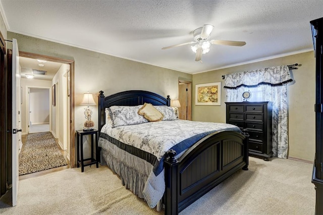 bedroom with a textured ceiling, crown molding, a ceiling fan, and light carpet