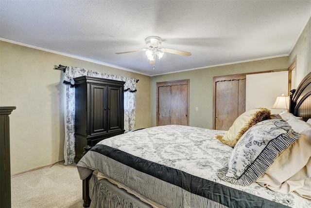 bedroom featuring a textured ceiling, crown molding, baseboards, light colored carpet, and ceiling fan