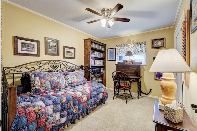 carpeted bedroom featuring baseboards, a ceiling fan, and crown molding