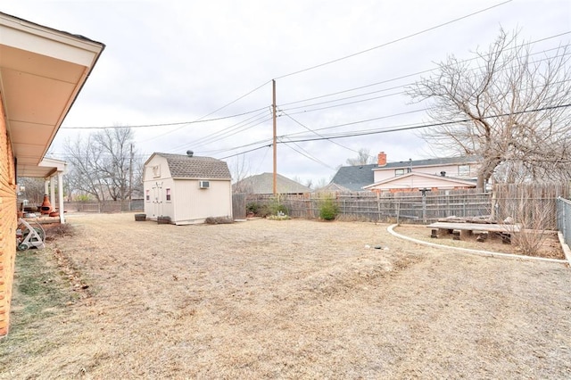 view of yard featuring a fenced backyard, a shed, and an outdoor structure