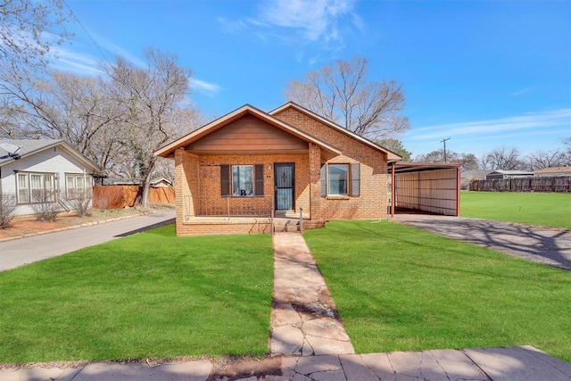 view of front facade with brick siding, a front lawn, and fence