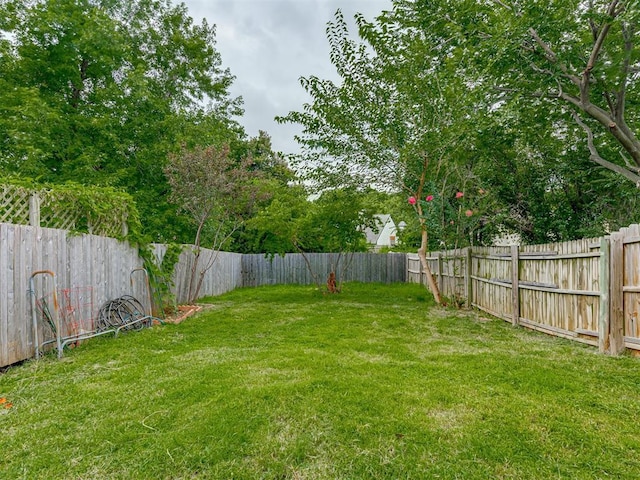 view of yard with a fenced backyard