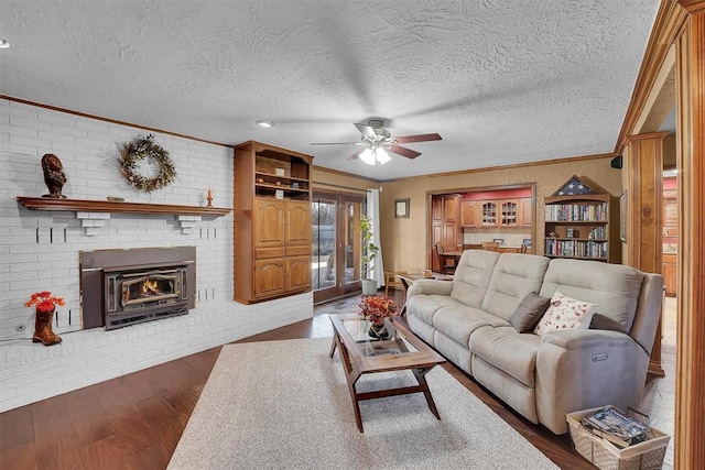 living area featuring crown molding, dark wood-style floors, and a textured ceiling