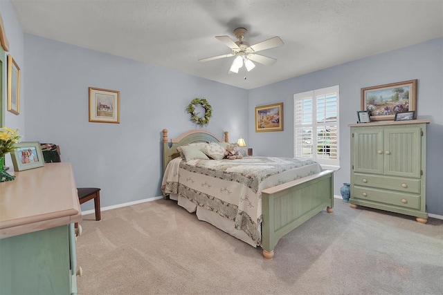 bedroom featuring ceiling fan, baseboards, and light carpet