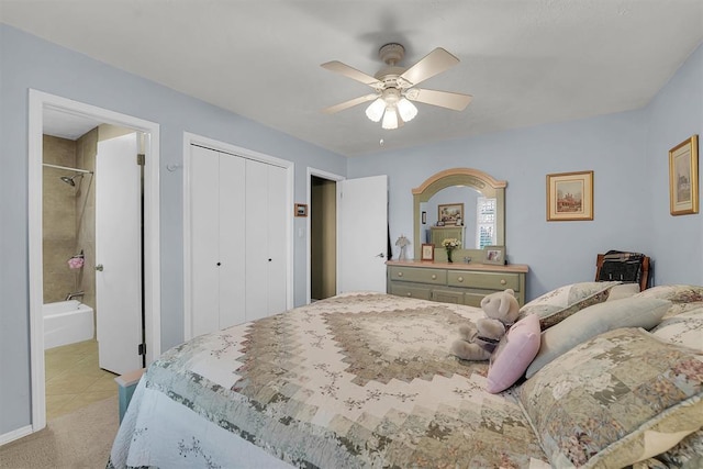 bedroom with a closet, light colored carpet, ensuite bathroom, and ceiling fan