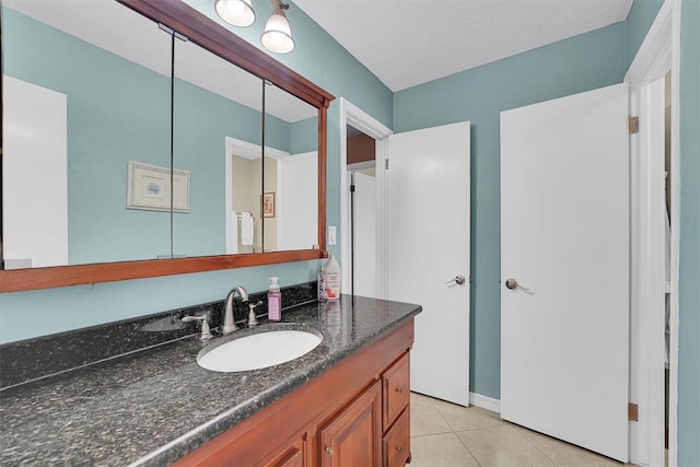 bathroom with tile patterned flooring and vanity