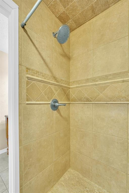 full bath with a tile shower