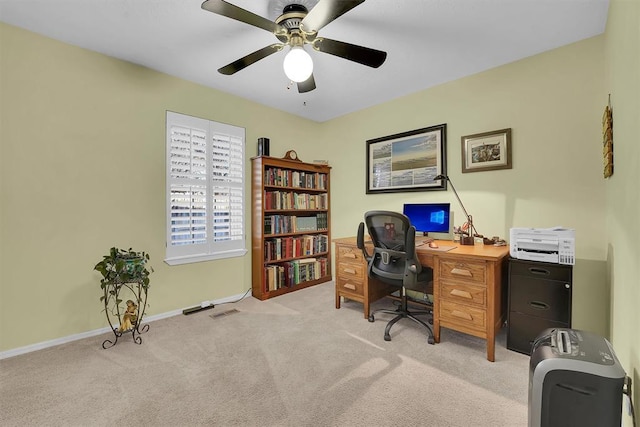 home office featuring visible vents, light colored carpet, baseboards, and ceiling fan