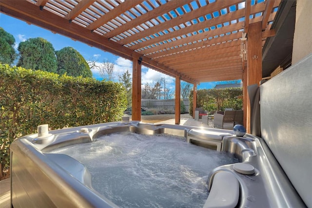 view of patio featuring a hot tub and a fenced backyard