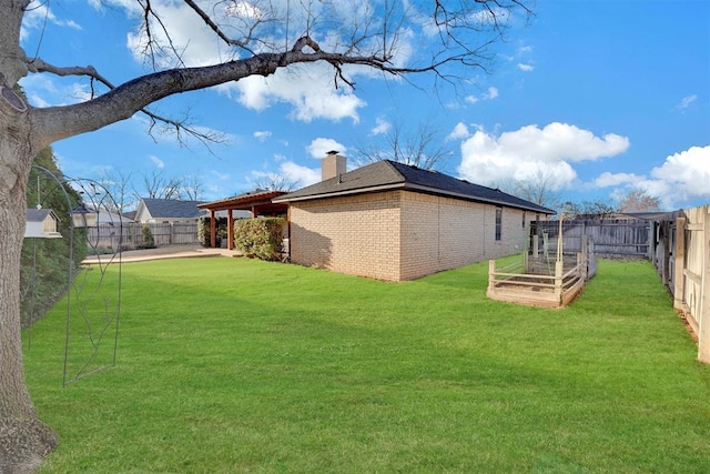 view of yard featuring a fenced backyard and a garden