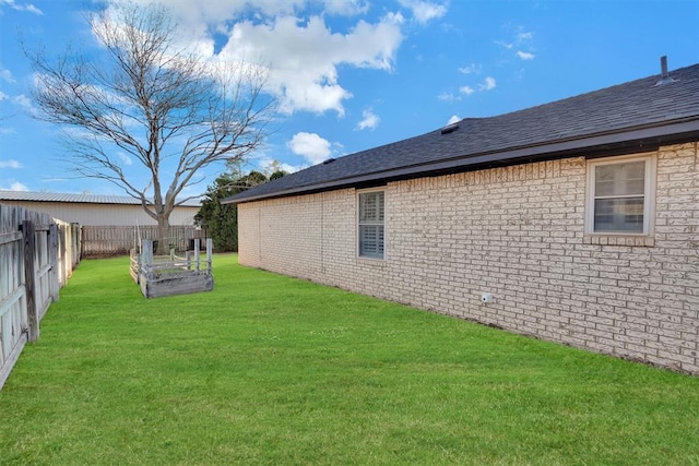 view of yard with a garden and fence