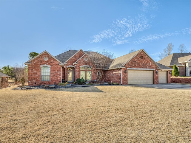 view of front of home with brick siding, an attached garage, a front lawn, and roof with shingles