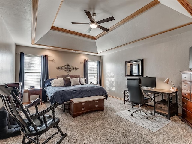 bedroom with a raised ceiling, multiple windows, light colored carpet, and ornamental molding