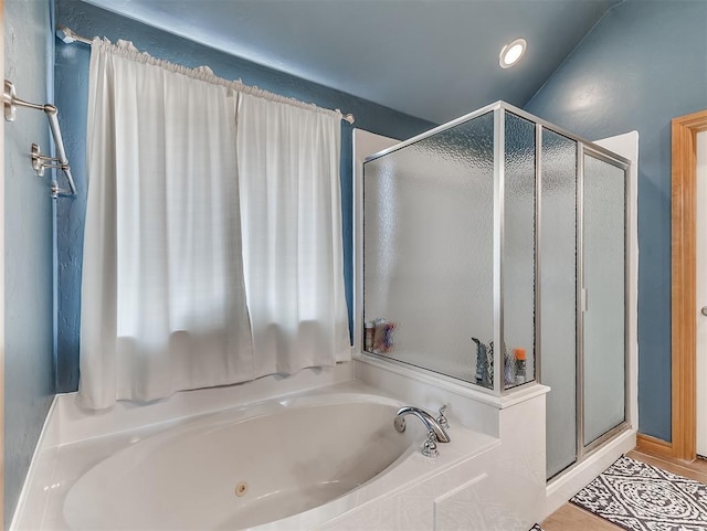 bathroom featuring a bath and a shower stall