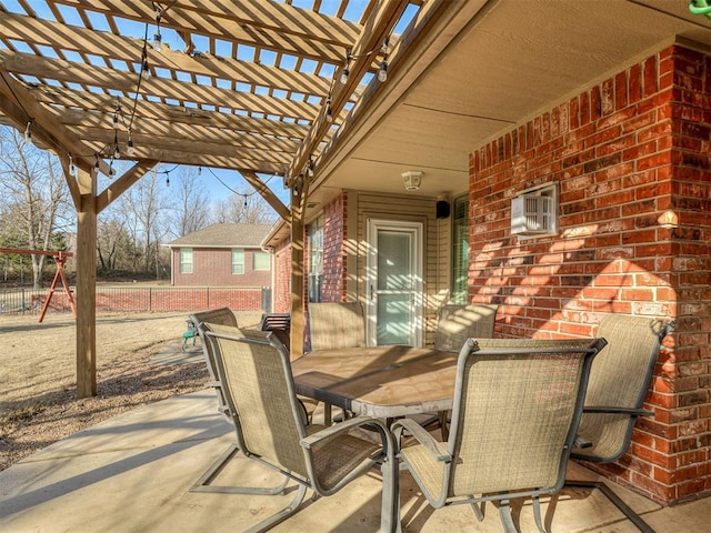 view of patio / terrace with a wall unit AC, fence, outdoor dining space, and a pergola