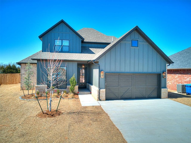 view of front of home featuring driveway, fence, board and batten siding, roof with shingles, and a garage