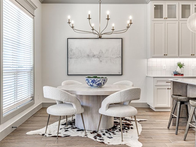 dining space featuring a notable chandelier, light wood-style floors, and a healthy amount of sunlight