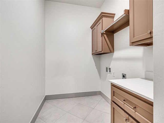 laundry area with light tile patterned floors, baseboards, hookup for an electric dryer, and hookup for a washing machine