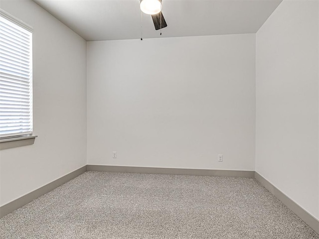 spare room featuring ceiling fan, baseboards, and carpet floors