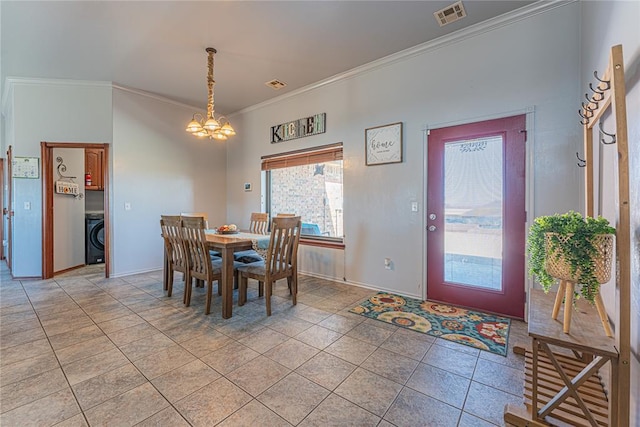 dining space with visible vents, a notable chandelier, ornamental molding, washer / clothes dryer, and light tile patterned floors