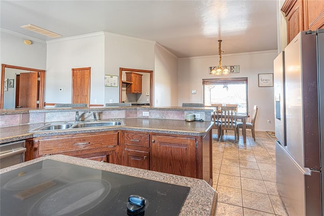 kitchen with visible vents, stainless steel fridge, ornamental molding, and a sink